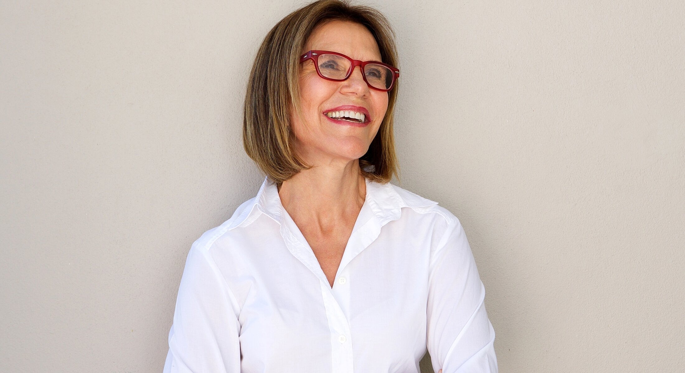 Woman holding clear silicone breast implants.