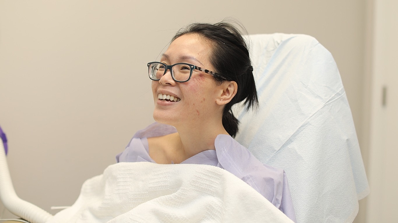 Smiling woman in a medical setting.
